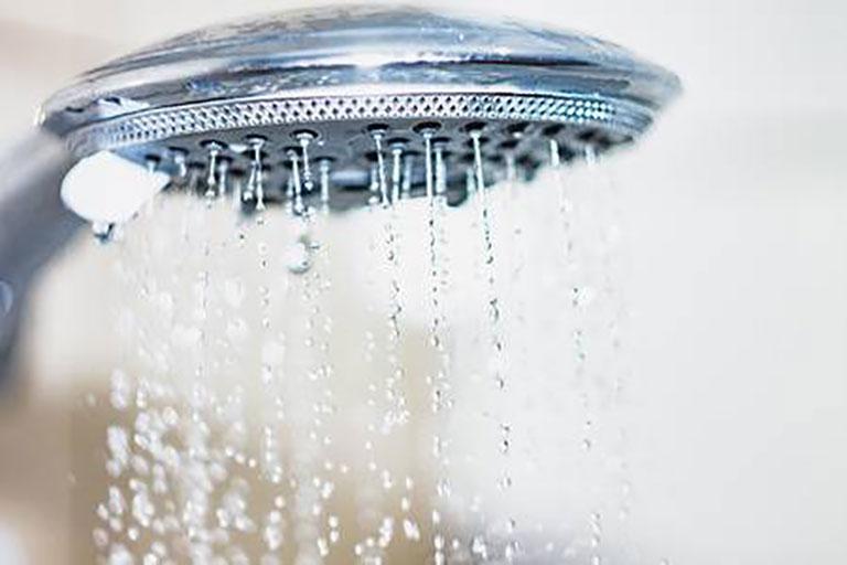 98217564-shower-head-with-drops-of-water-falling-down
